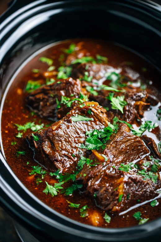 Slow cooker round steak simmering in rich brown gravy inside a crockpot