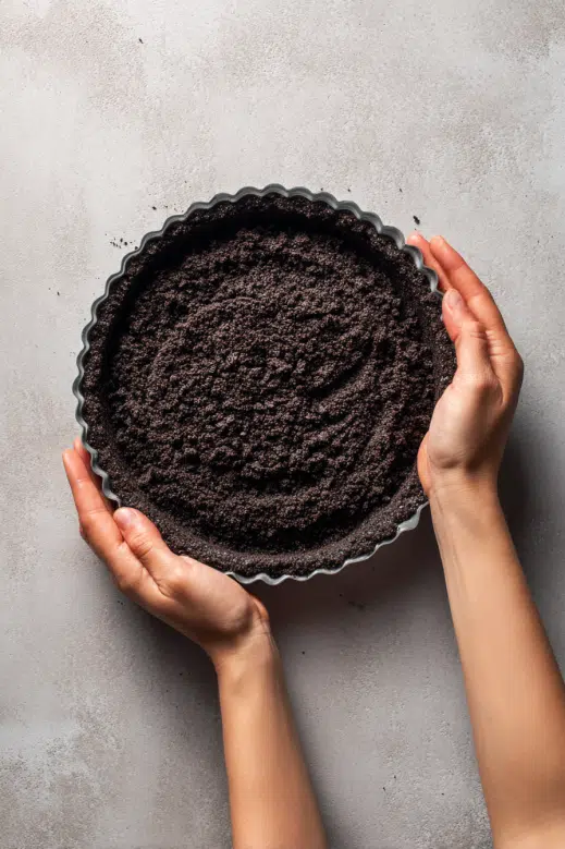 Pressing Oreo crust into pie dish	