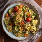 Tortellini with Summer Veggies: A Fresh, Easy Weeknight Favorite 7 Served bowl of tortellini with zucchini, cherry tomatoes, and red onion