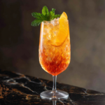 Hugo Spritz Recipe The Best Refreshing Cocktail to Sip All Summer 6 Hugo spritz recipe in crystal glass with orange slice and mint