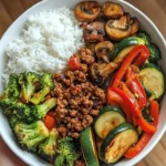 spicy ground beef stir fry bowl with garlic veggie 2026 01 01 201508 1